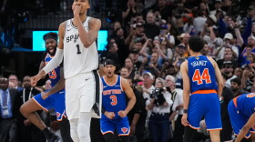 San Antonio Spurs forward Victor Wembanyama walks off the court as time expires during the second half of Game 2 of the NBA Finals basketball series as New York Knicks guard Landry Shamet (44), guard Josh Hart (3), and center Mitchell Robinson (23) celebrate, Friday, June 5, 2026, in San Antonio.