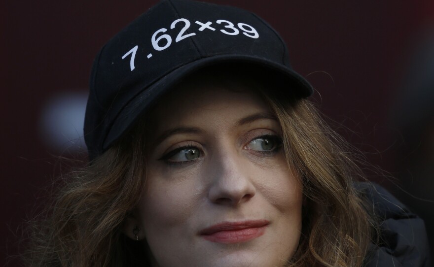 A woman wears a hat with the caliber of an AK-47 rifle round written on it at the rally last month in Seattle.