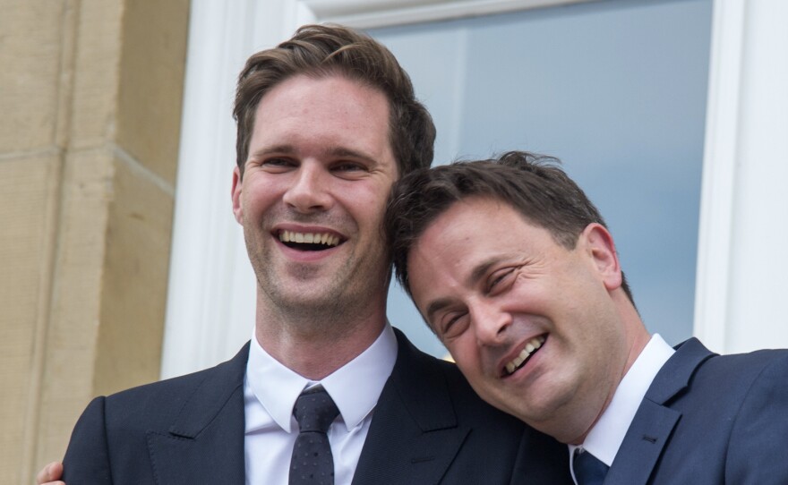 Luxembourg's Prime Minister Xavier Bettel, right, puts his arm around his partner Gauthier Destenay as they leave the town hall after their marriage in Luxembourg on Friday.