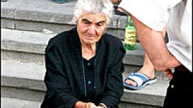 On the steps of Gori City Hall, an elderly woman waits for the local government to determine what to do with her and the town's other residents whose homes were destroyed in the recent fighting with Russia's invading army.