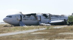 National Transportation Safety Board officials handed out this photo of the burnt shell of Asiana Flight 214 during their first assessment of the crash. Two people died Saturday and scores more were injured.