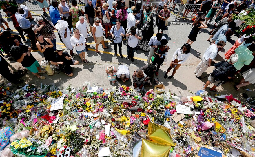 People pay respects outside of Emanuel African Methodist Church in June 2015 after a mass shooting that claimed the lives of nine people in Charleston, South Carolina.