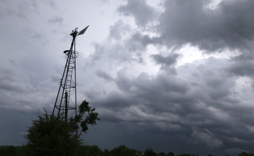 Storm clouds that were part of a system that produced several tornadoes move past a windmill on a farm near Ozawkie, Kan., in 2016.