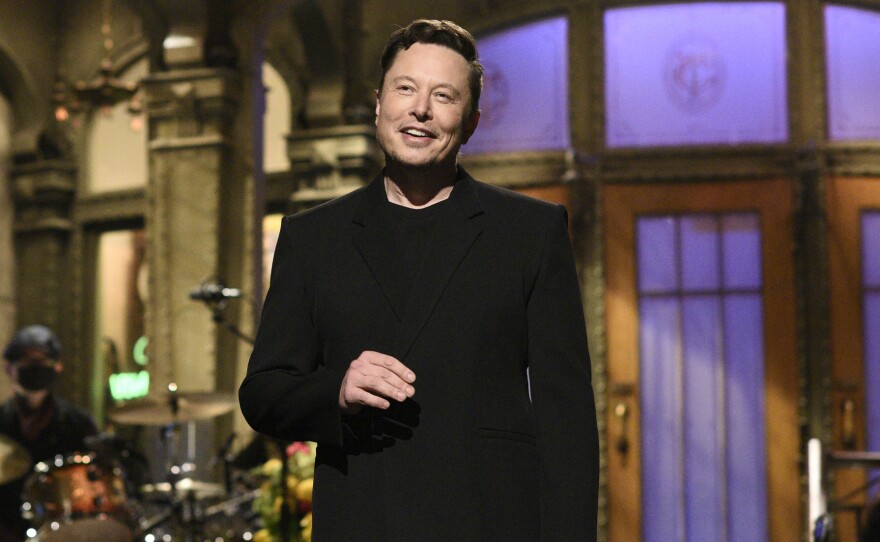 Tesla CEO Elon Musk delivers his opening monologue on "Saturday Night Live" last week in an image released by NBC. Musk tweeted on Wednesday that Tesla would no longer accept cryptocurrency Bitcoin for car purchases.