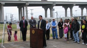 City Council President Ben Hueso stands at the site of the Mercado Project and explains to reporters and residents how the development plan will help transform Barrio Logan, June 29, 2010.
