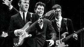 The Shadows on stage in the 1960s. The British rock act, formed as a backing band for singer Cliff Richard (center), was among the U.K. acts who stayed behind as The Beatles and others were cresting in America.