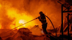 Firefighters put out a fire after Russian missiles hit a warehouse in Kyiv, Ukraine, Wednesday, Aug. 5, 2026.