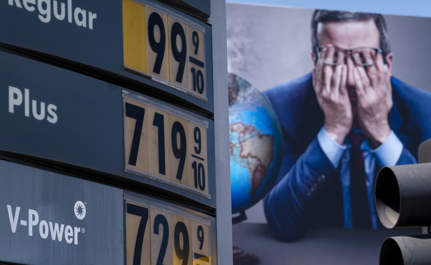 Gas prices are seen in front of a billboard advertising HBO's Last Week Tonight in Los Angeles, March 7, 2022.