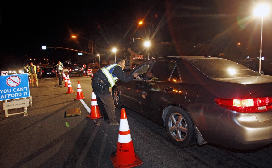 Police officers check drivers at a sobriety checkpoint in Escondido, Calif., on Dec. 16, 2011.
