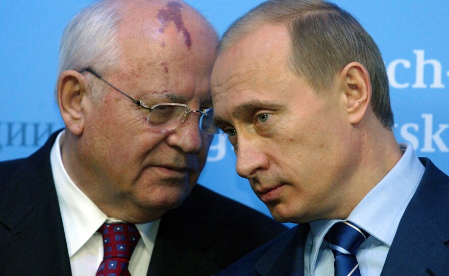Russian President Vladimir Putin (R) talks to former Soviet President Mikhail Gorbachev (L) before a press conference of German Chancellor Gerhard Schroeder and Putin at Gottorf castle in Schleswig on Dec. 21 2004.