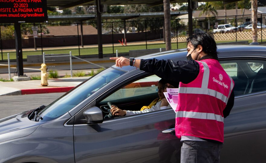 A Universidad Popular volunteer directs a resident to La Mirada Academy’s vaccination clinic location in San Marcos, Calif. in this undated photo.