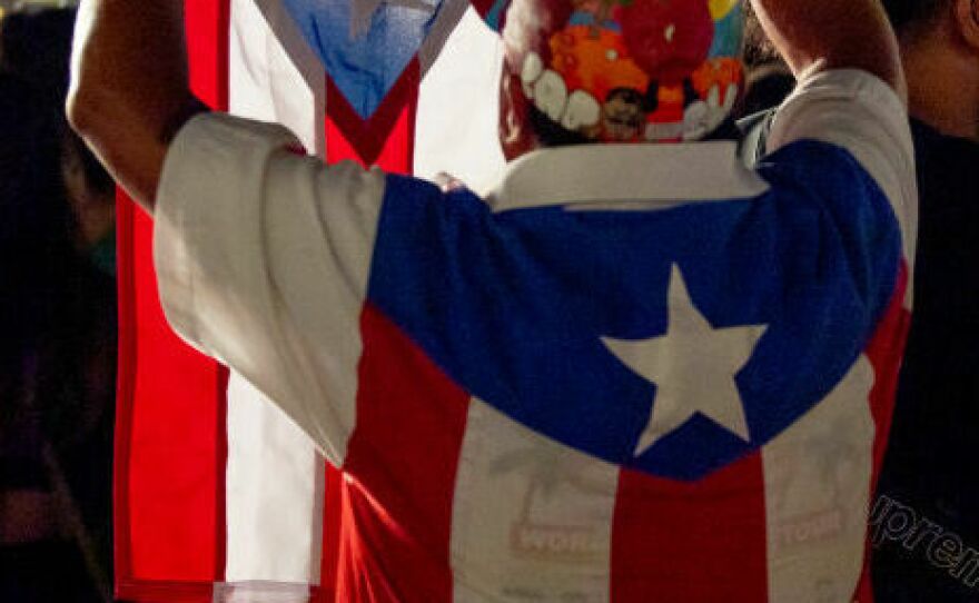 Member of the audience wears a Puerto Rico flag as Bad Bunny performs at Yankee Stadium in 2022.