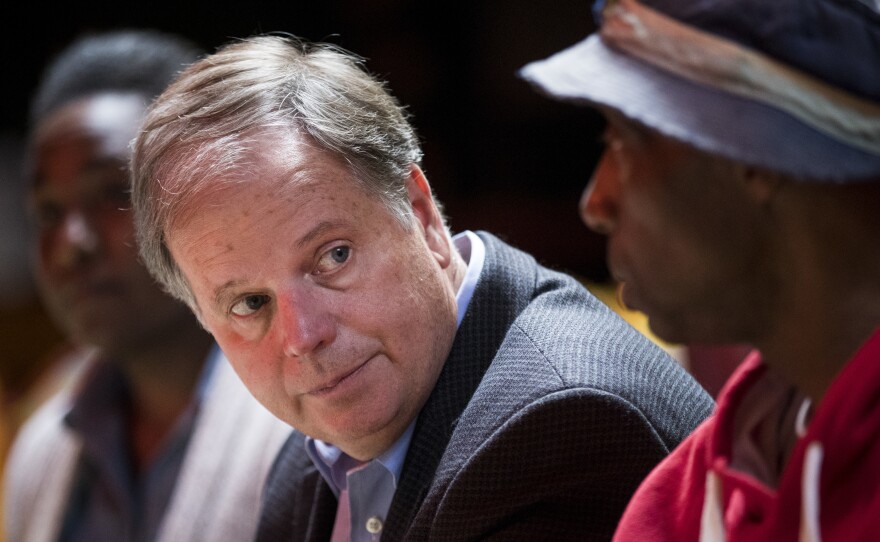 Democratic Senate candidate Doug Jones meets with supporters last month in Talladega, Ala.