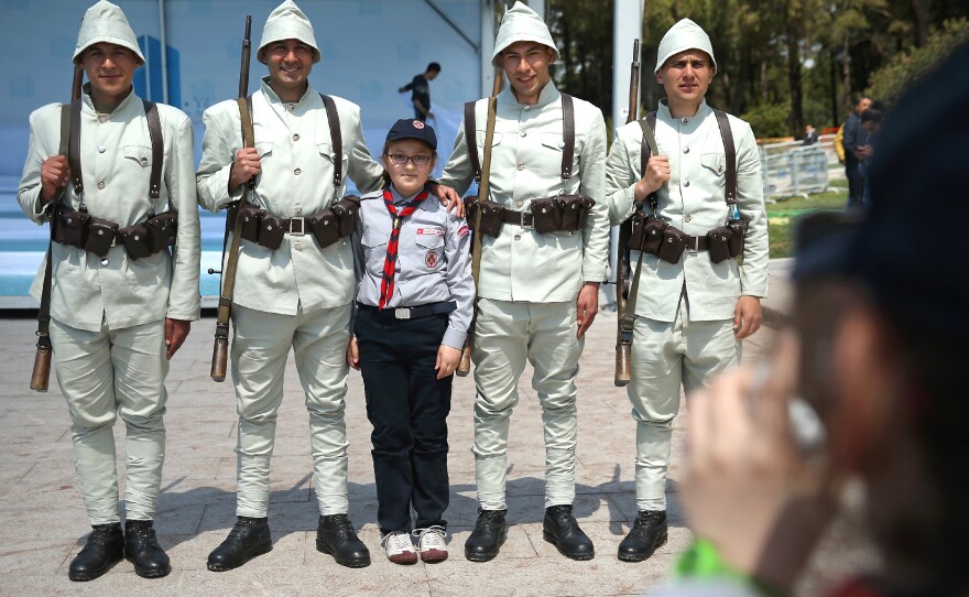 Turkish schoolkids photograph one another next to soldiers dressed as World War I Ottoman troops at the Canakkale Martyrs' Memorial. The memorial, near Sedd el-Bahr, Turkey, is a tribute to the Ottoman victory at Gallilpoli in 1915 over British, French, Australian and New Zealand soldiers.