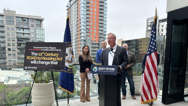 Rep. Scott Peters, D-San Diego, speaks at a media event highlighting the importance of the 21st Century ROAD to Housing Act. Behind him are Carlynne Yu, CFO of the Regional Task Force on Homelessness; James Silverwood, President of Affirmed Housing; and Stephen Russel, President and CEO of the San Diego Housing Federation.