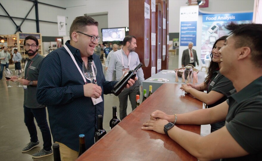 Host Jorge Meraz does some wine tasting at an international wine event held in the Baja Center.