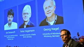 Karl Deisseroth, Peter Hegemann and Georg Nagel are shown on the screen as they are awarded the 2026 Nobel Prize in Physiology or Medicine, as announced during a press conference at the Nobel Forum at Karolinska Institutet in Stockholm, Sweden, Oct. 5, 2026.