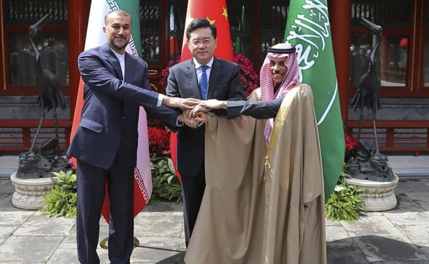 In this picture released by the Iranian Foreign Ministry, Iran's Foreign Minister Hossein Amirabdollahian, left, shakes hands with his Saudi Arabian counterpart Prince Faisal bin Farhan Al Saud, right, and Chineses counterpart Qin Gang in Beijing Thursday, April 6, 2023.