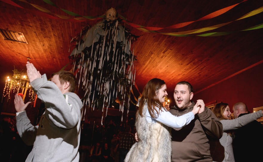 Couples square dance at the foot of the Old Man winter effigy hanging at the center of the Community Hall. Residents and visitors to Helvetia, W.Va., celebrated Fasnacht, a pre-Lenten celebration marked by the eating of rich foods and the burning an effigy of Old Man Winter on a bonfire at midnight, Feb. 14, 2015.