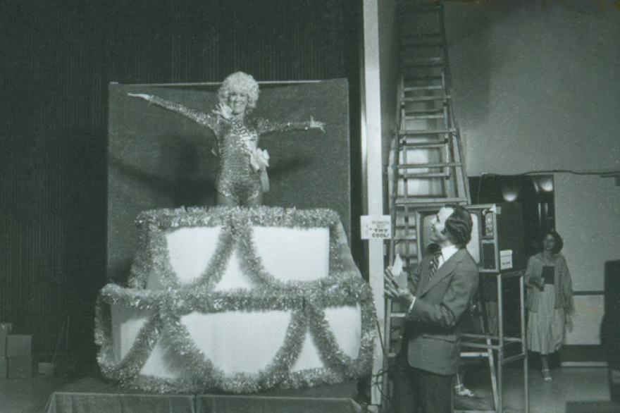 Ken Kramer (right) welcomes a performer on stage during a KPBS auction.