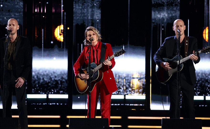 Brandi Carlile (center) performs with her longtime collaborators Phil Hanseroth (left) and Tim Hanseroth, at the 2021 Rock & Roll Hall of Fame Induction Ceremony on October 30, 2021 in Cleveland, Ohio.