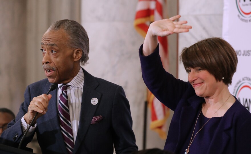 The Rev. Al Sharpton and Sen. Amy Klobuchar, D-Minn. at a November 2018 meeting of Sharpton's National Action Network on Capitol Hill. Klobuchar and other Democrats weighing a presidential bid have been courting the black community more intensively than past election cycles.