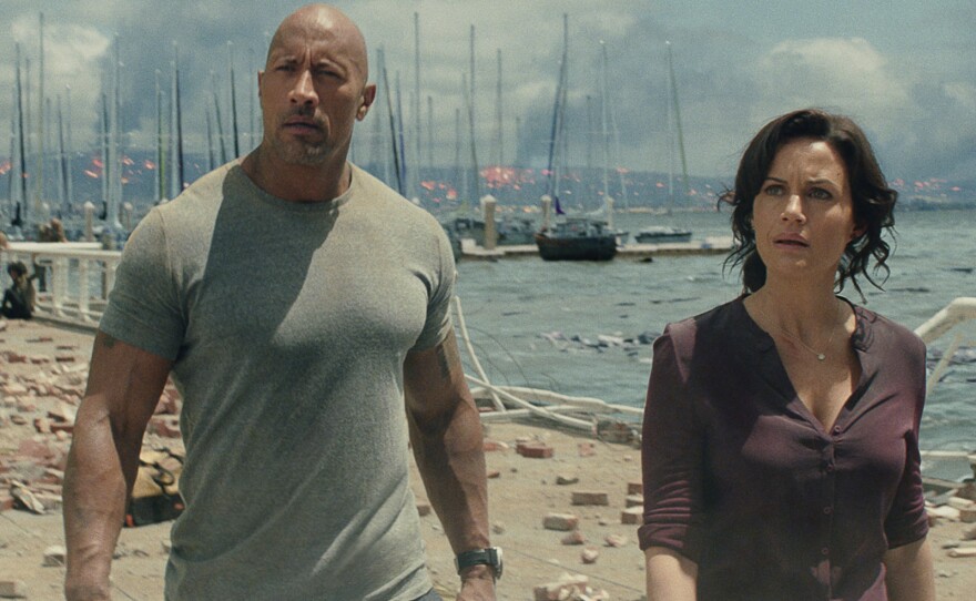 Dwayne Johnson and Carla Gugino survey the post-earthquake wreckage.