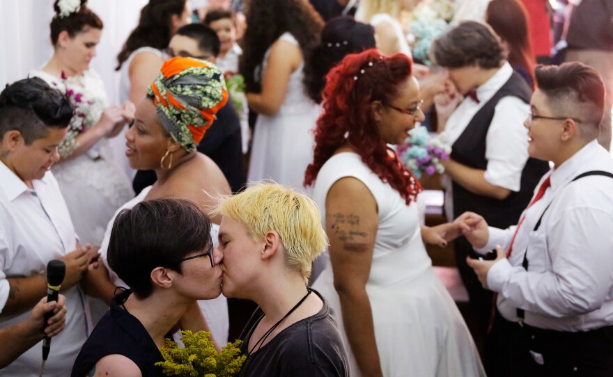 A couple kiss as they get married during a group wedding of same-sex couples in São Paulo in December. After Bolsonaro's election in October, hundreds of same-sex couples began to marry, fearing that their right to do so will be curtailed by the new administration.