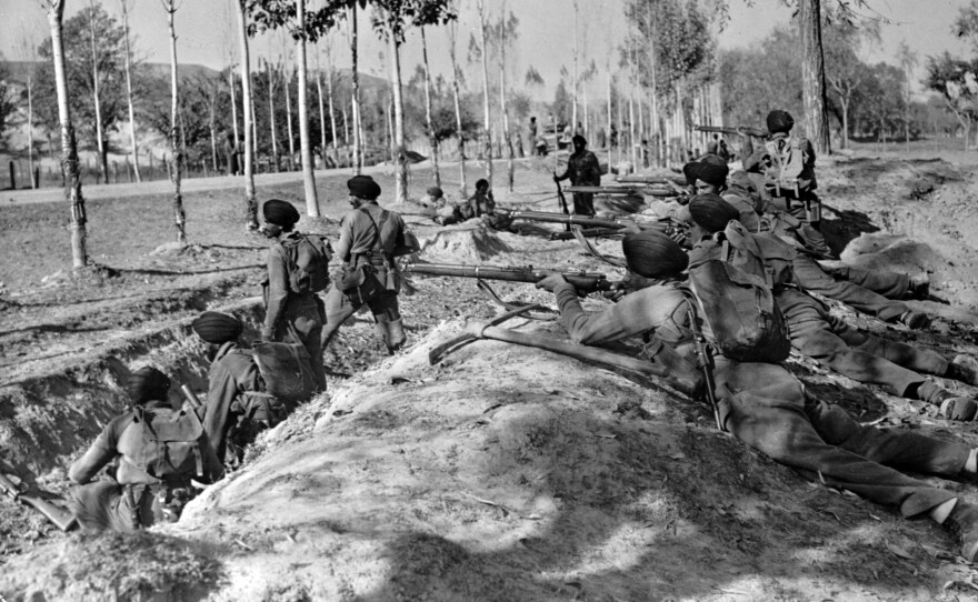 In this Nov. 9, 1947, file photo, Indian Sikh troops take up roadside positions on the Baramula Road to help force armed invaders from Pakistan further away from Srinagar in Kashmir. India and Pakistan fought a yearlong war over control of Muslim-majority Kashmir. The war ended with a U.N.-brokered cease-fire leaving Kashmir divided between the two young nations.