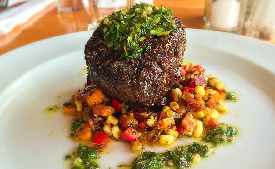 Pan-seared buffalo tenderloin with a corn and sweet potato hash and chimichurri sauce is served up at The Local, a restaurant in Jackson, Wyo.