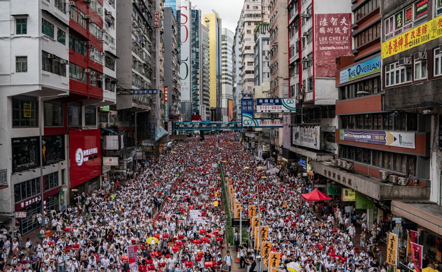 Protesters march on a street during a rally against the extradition law proposal on June 9, 2019 in Hong Kong.