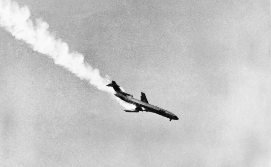 Pacific Southwest Airlines Flight 182, with its wing aflame after a collision with a smaller plane, plunges to earth killing all passengers and crew, in San Diego, Sept. 25, 1978.