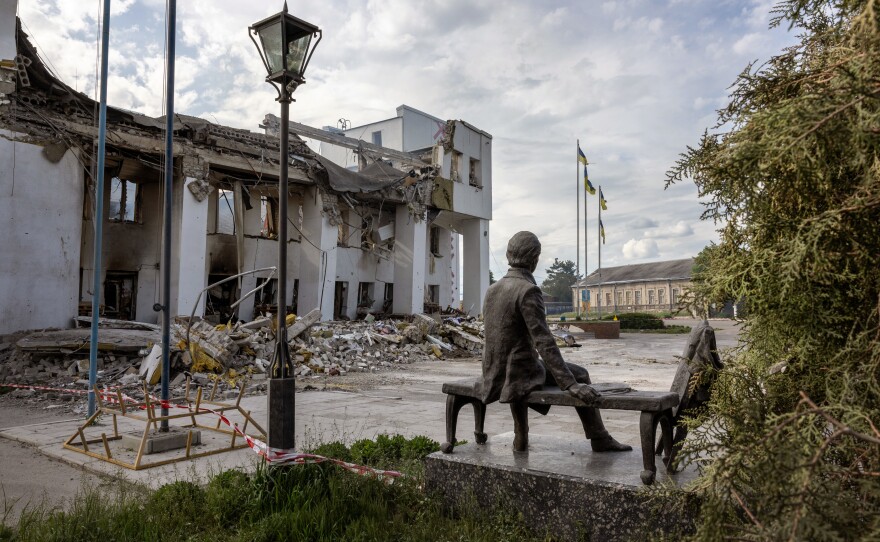 A sculpture of Ukrainian national hero and bard Taras Shevchenko sits near the ruins of the local Palace of Culture in Dergachi, Ukraine, on May 14. The building had most recently been used as a humanitarian aid distribution center for Ukrainian civilians before being destroyed by a missile strike on May 11.