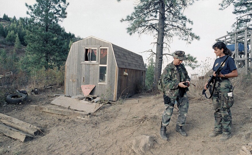 Agents with the Bureau of Alcohol, Tobacco and Firearms stand next to the outbuilding located near the Randy Weaver home near Naples, Idaho, in September 1992.