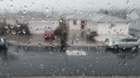 Rain is seen on a window looking out on to a street in Oak Park, Dec. 12, 2014. 
