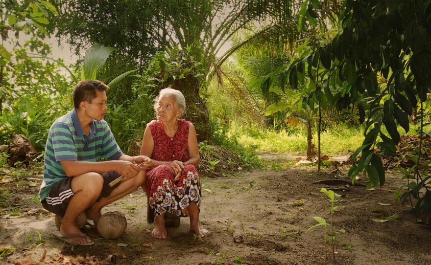 Adi and his mother, Rohani, share a solemn moment.