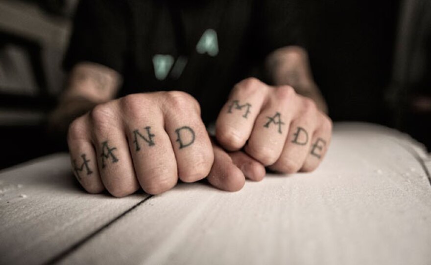 Close up of Jeff McCallum's hands with tattoo "Hand Made."