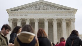 People wait outside to enter the U.S. Supreme Court in Washington, Nov. 3, 2014. 