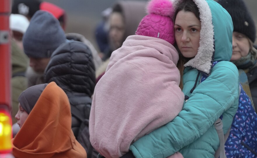 Refugees, mostly women with children, wait for transportation at the border crossing in Medyka, Poland, Saturday, March 5, 2022, after fleeing from Ukraine.