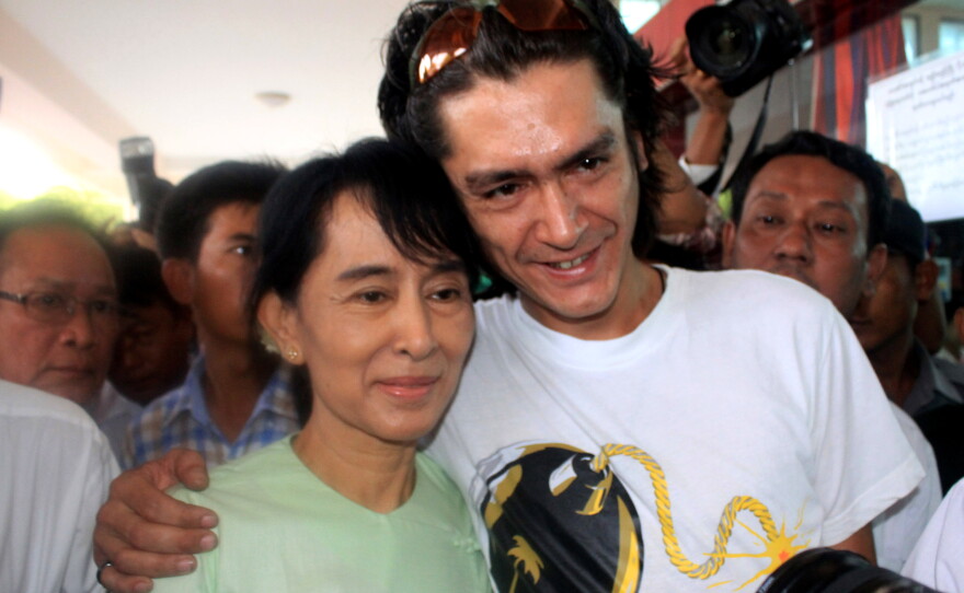 Myanmar's former leader Aung San Suu Kyi and her son Kim Aris pose for a photo at Bagan airport before leaving for Yangon, Myanmar, on July 8, 2011.