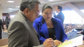 Latino community leaders Artie Blanco and Fernando Romero examine a map of Las Vegas' Latino neighborhood at the April 2 legislative redistricting hearing.