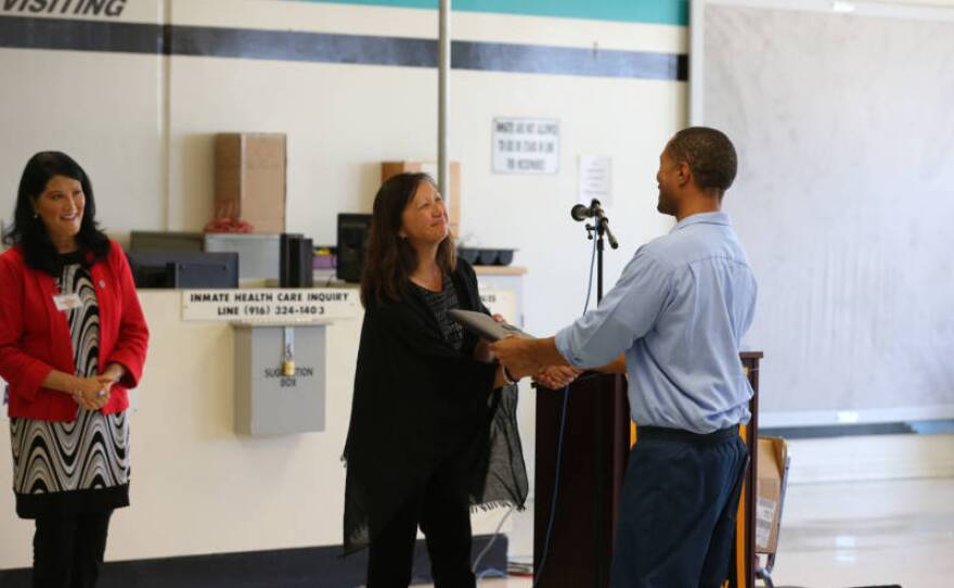 Taffany Lim, who helped to create the B.A. program and now runs it, greets participating student inmates during an event at a state prison in Lancaster in fall 2019.