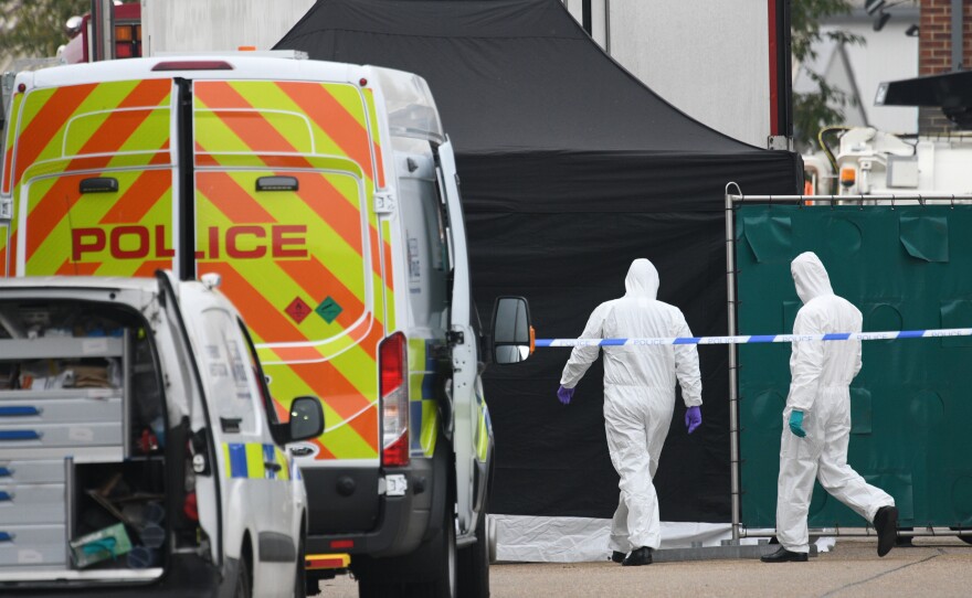 A police forensic investigation team walks near the site where 39 bodies were discovered in the back of a truck on Wednesday in Waterglade Industrial Park in Grays, England. Police believe the truck is from Bulgaria, a member of the European Union, and that it entered the U.K. on Saturday at Holyhead.