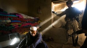 A scene from "Hell And Back Again" with Marines entering a home in Southern Afghanistan.