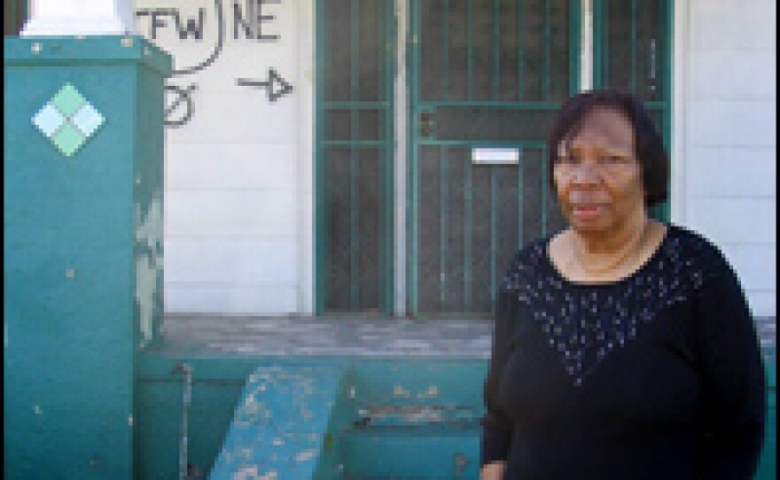 Ethel Williams stands in front of her house on Pauline Street. Despite two visits by President Bush, her property risks being condemned.