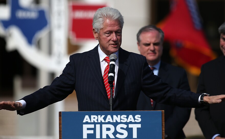 Former President Bill Clinton campaigns before the 2014 elections for former Sen. Mark Pryor, center, and Mike Ross, right, the Democratic candidate for governor.