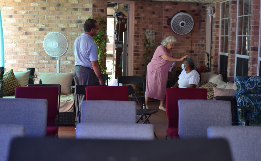 A longtime member of the Iglesia Pentecostal Providencia Divina blesses another church member at the makeshift church in Pastor Rivera's home in early October.