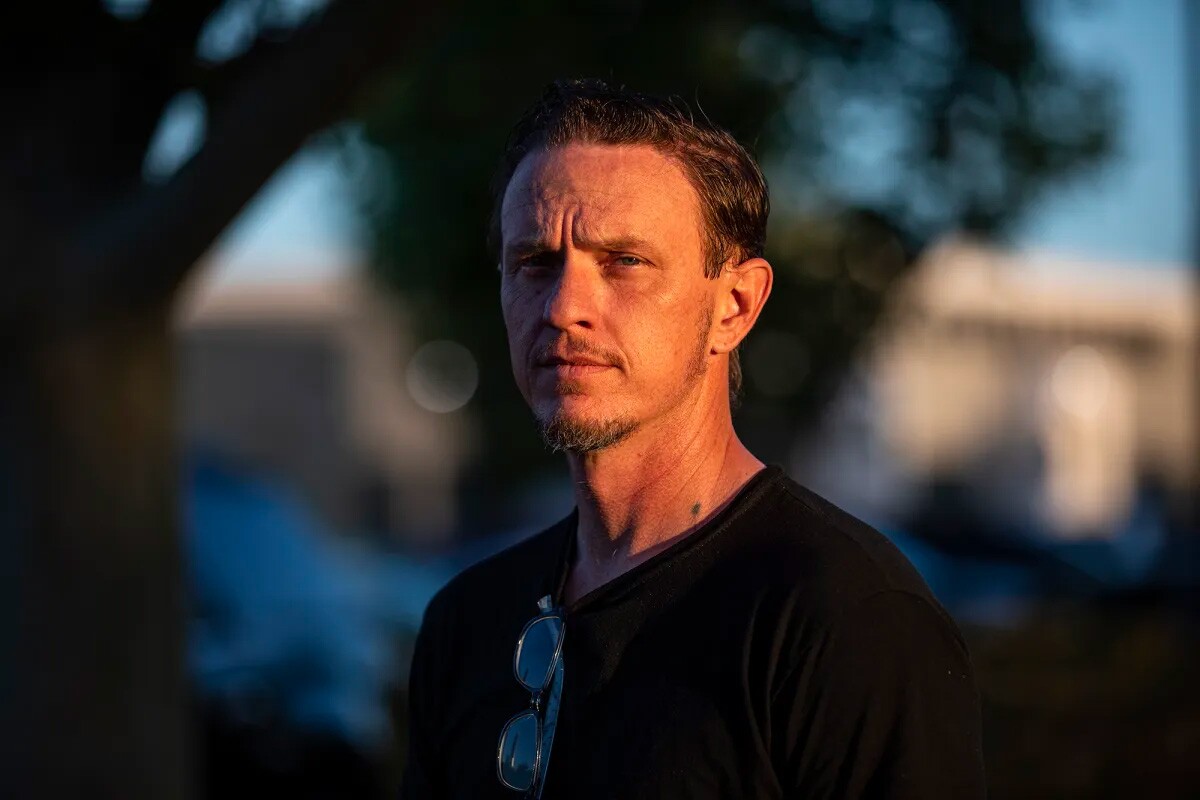 David Zemp stands on the sidewalk near a street in Lancaster on May 10, 2023. Zemp is a former inmate but is now getting ready to graduate from college courses he took while incarcerated.