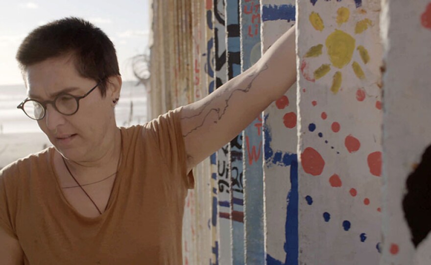 Tanya Aguiñiga at the U.S.-Mexico border wall, Tijuana, Mexico. Production still from the Art21 television series ART IN THE TWENTY-FIRST CENTURY Season 10, 2020.