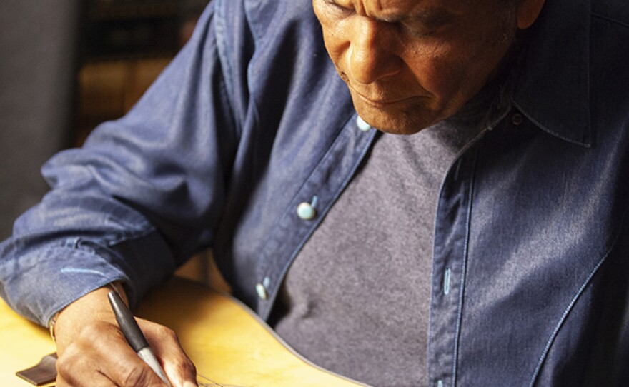 Charley Pride signs Martin D-28 guitar. Pride is among the 76 of the 101 country music artists interviewed for the series who signed two Martin D-28 guitars.